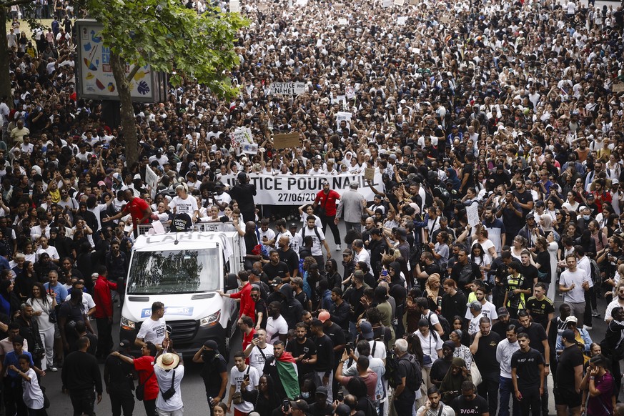 epa10717402 People carry a banner reading &#039;Justice for Nahel&#039; as they attend a march in the memory of 17-year-old Nahel, who was killed by French Police in Nanterre, near Paris, France, 29 J ...