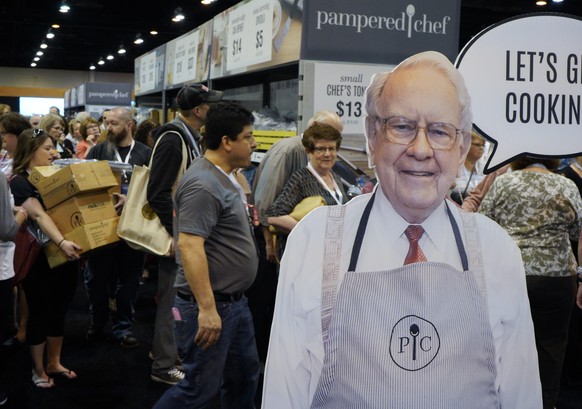 A Warren Buffett cutout stands in front of Berkshire Hathaway shareholders shopping for kitchen supplies at the Pampered Chef display at the CenturyLink Center in Omaha, Neb., Friday, May 4, 2018, whe ...