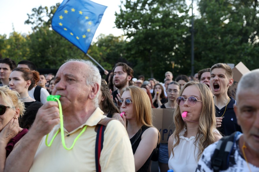 epa10735008 Protestors blow into whistles during a rally against violence, in Belgrade, Serbia, 08 July 2023. Opposition political parties have called on a peaceful protest against violence in Serbian ...