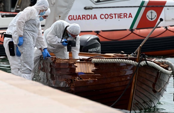 Italian forensic police inspect the damage on a boat as they investigate two German tourists from Munich for a boat collision which killed an Italian man and woman, in Salo&#039;, on Lake Garda, north ...