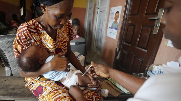 FILE- A health worker administers the malaria vaccine R21/Matrix-M to a child at the comprehensive Health Centre in Agudama-Epie, in Yenagoa, Nigeria, Monday, Dec. 9, 2024. (AP Photo/Sunday Alamba, Fi ...