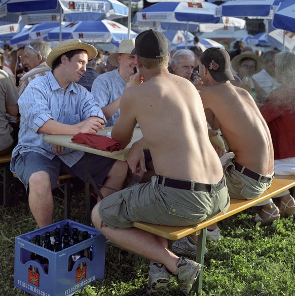 Visitors sit at long tables and have beer in the refreshment and festivities area at the Swiss Alpine Wrestling and Herdsman Festival 2007 on the Schachen area in Aarau in the canton of Aargau, Switze ...