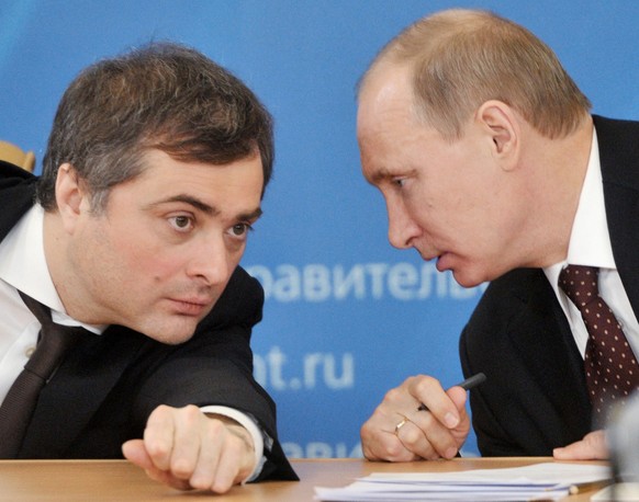 FILE - In this Feb. 13, 2012 file photo, , Russian Prime Minister Vladimir Putin, right, speaks to Vladislav Surkov, deputy prime minister in charge of economic modernization, during a visit in Kurgan ...