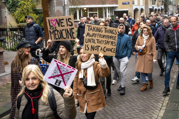 epa09593925 Protesters demonstrate against the coronavirus pandemic measures, in Amsterdam, The Netherlands, 20 November 2021. The announced demonstration was canceled by the organizers because of the ...