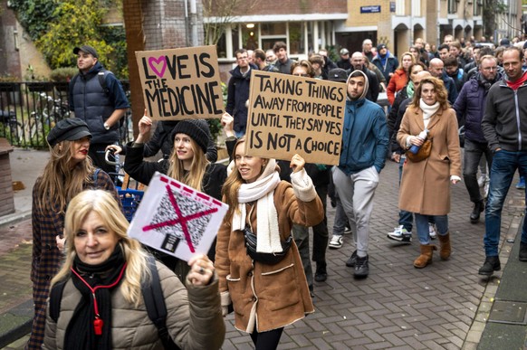 epa09593925 Protesters demonstrate against the coronavirus pandemic measures, in Amsterdam, The Netherlands, 20 November 2021. The announced demonstration was canceled by the organizers because of the ...