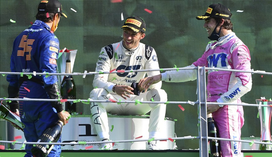 Race winner AlfaTauri driver Pierre Gasly of France, centre, speaks on the podium with second placed Mclaren driver Carlos Sainz of Spain, left, and third placed Racing Point driver Lance Stroll of Ca ...