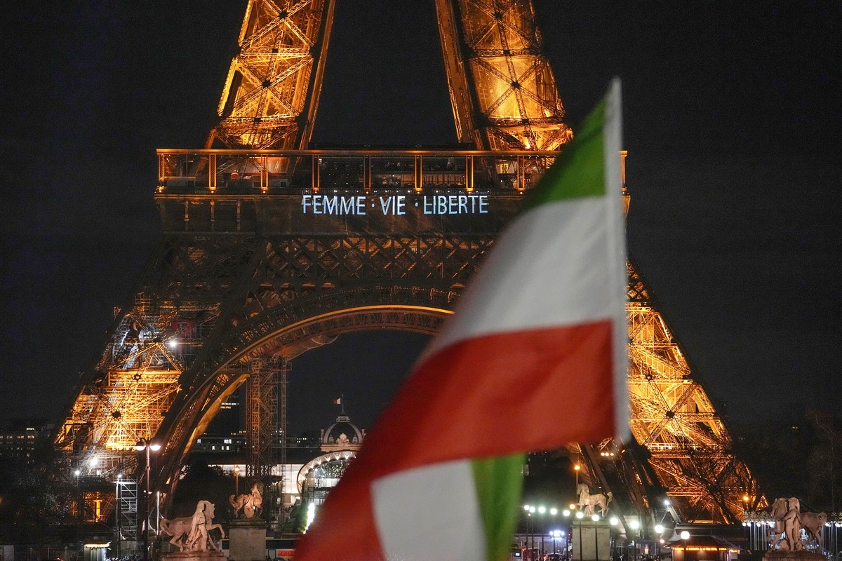 The Eiffel Tower lits the night with the a slogans "Woman, Life, Freedom" and "Stop Executions in Iran in support for the protests across Iran in Paris, Monday, Jan. 16, 2023, as a Iran ...
