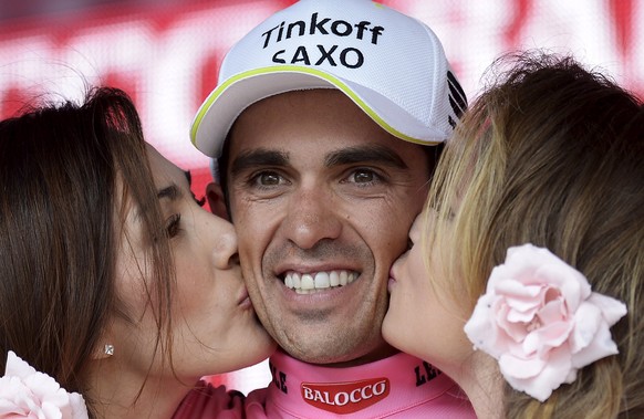 Tinkoff-Saxo rider Alberto Contador of Spain receives kisses as he wears the leader's pink jersey after the 236 km 98th Giro d'Italia (Tour of Italy) cycling race from Gravellona Toce to Cervinia, Ita ...