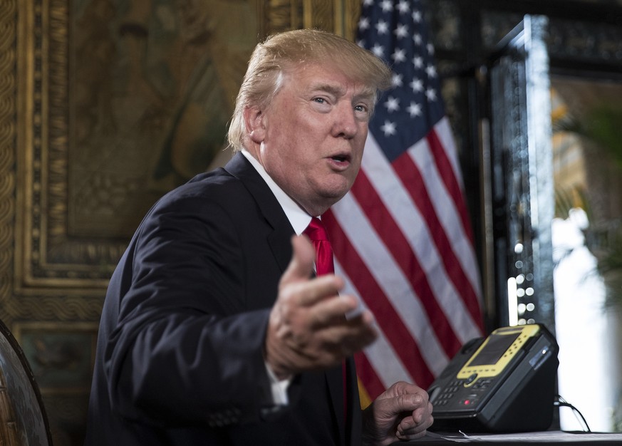 FILE - In a Sunday, Dec. 24, 2017 file photo, President Donald Trump turns to talk to the gathered media during a Christmas Eve video teleconference with members of the mIlitary at his Mar-a-Lago esta ...