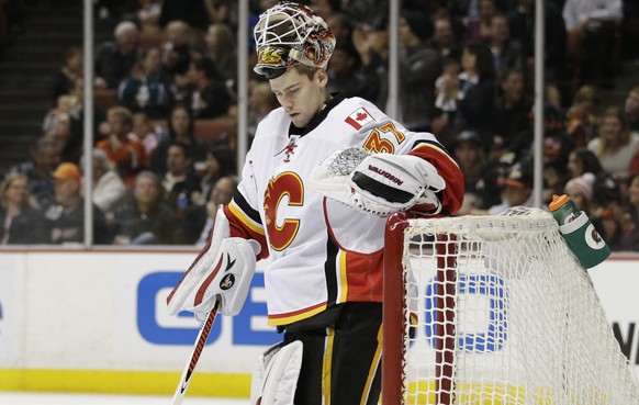 Calgary Flames goalie Joni Ortio, of Finland, stands in front his net after giving up the fourth goal to the Anaheim Ducks, during the second period of an NHL hockey game Wednesday, Jan. 21, 2015, in  ...