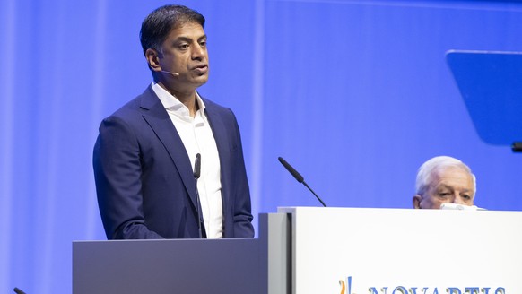 epa11946613 Novartis CEO Vas Narasimhan (L) delivers a speech during the annual general meeting of Swiss pharmaceutical corporation Novartis in Basel, Switzerland, 07 March 2025. EPA/URS FLUEELER