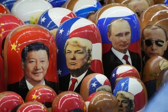 Traditional Russian wooden dolls called Matryoshka depicting China&#039;s President Xi Jinping, U.S. President-elect Donald Trump and Russian President Vladimir Putin are displayed for sale at a souve ...