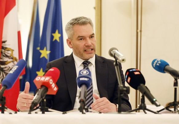 epa09884890 A handout photo made available by the Austrian Chancellery shows Austrian Chancellor Karl Nehammer at a press conference after his meeting with Russian President Putin, at the Austrian Emb ...