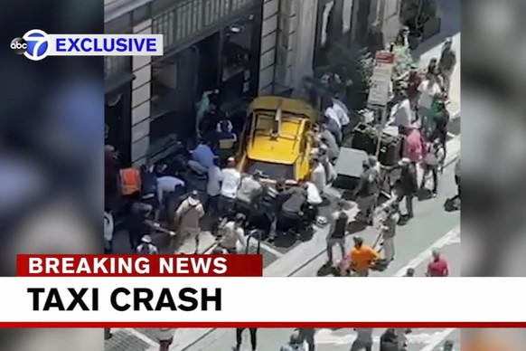 Bystanders move in to assist pedestrians who were struck by a cab that jumped a curb, Monday, June 20, 2022, in New York. A taxi cab turning onto a narrow section of Broadway hit a bicyclist, then swe ...