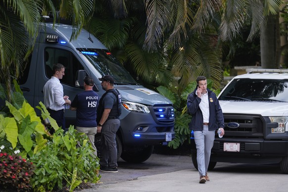 Law enforcement agents stand at the entrance to a property belonging to rapper Sean &quot;Diddy&quot; Combs, Monday, March 25, 2024, on Star Island in Miami Beach, Fla. Two properties belonging to Com ...