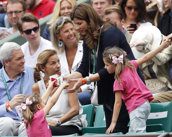 epa04233485 Mirka Federer and her daughters Myla Rose and Charlene Riva arrive on court to watch her husband Roger Federer of Switzerland play Dmitry Tursunov of Russia in their third round match for  ...