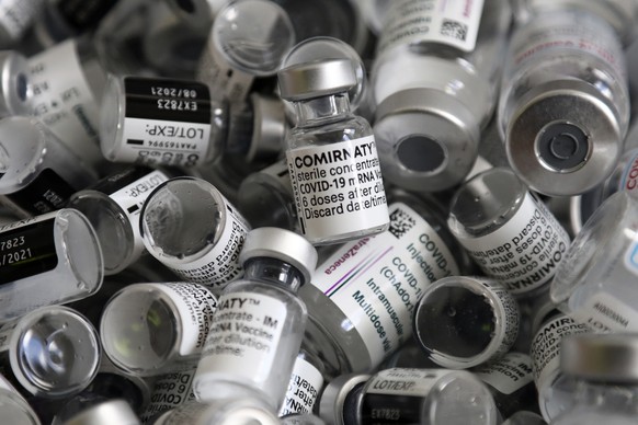 FILE - In this file photo dated Saturday, May 15, 2021, empty vials of the Pfizer-BioNTech COVID-19 vaccine lie in a box during a vaccine campaign at the Vaccine Village in Ebersberg near Munich, Germ ...
