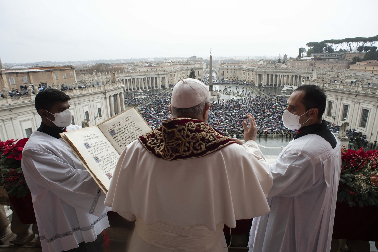 Pope Francis delivers the Urbi et Orbi (Latin for &#039;to the city and to the world&#039; ) Christmas&#039; day blessing from the main balcony of St. Peter&#039;s Basilica at the Vatican, Saturday, D ...