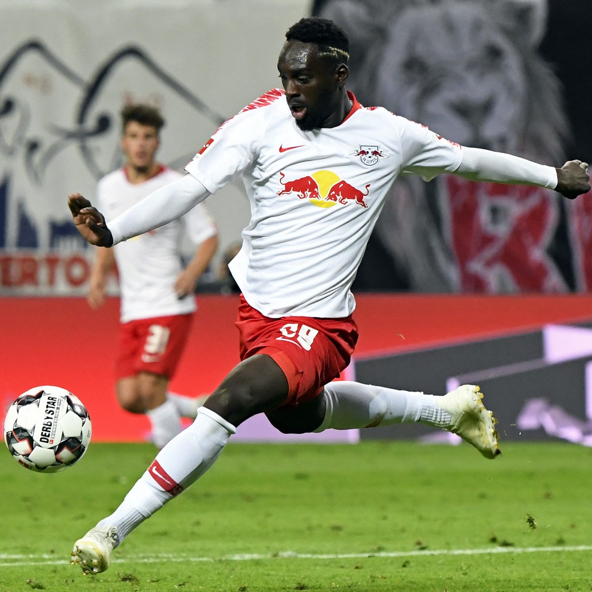 FILE - Leipzig's Jean-Kevin Augustin scores his side's 2nd goal during the German first division Bundesliga soccer match between RB Leipzig and VFB Stuttgart in Leipzig, Germany, Wednesday,  ...