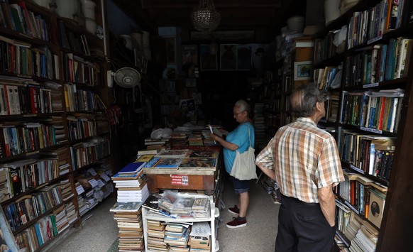 epa11667648 People inside a bookstore without electricity in Havana, Cuba, 18 October 2024. The Cuban government suspended non-essential state work activities starting this 18 October as part of the m ...