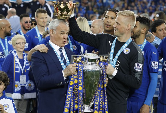Leicesters team manager Claudio Ranieri gets a crown by Leicesters goalkeeper Kasper Schmeichel as they lift the trophy as Leicester City celebrate becoming the English Premier League soccer champio ...