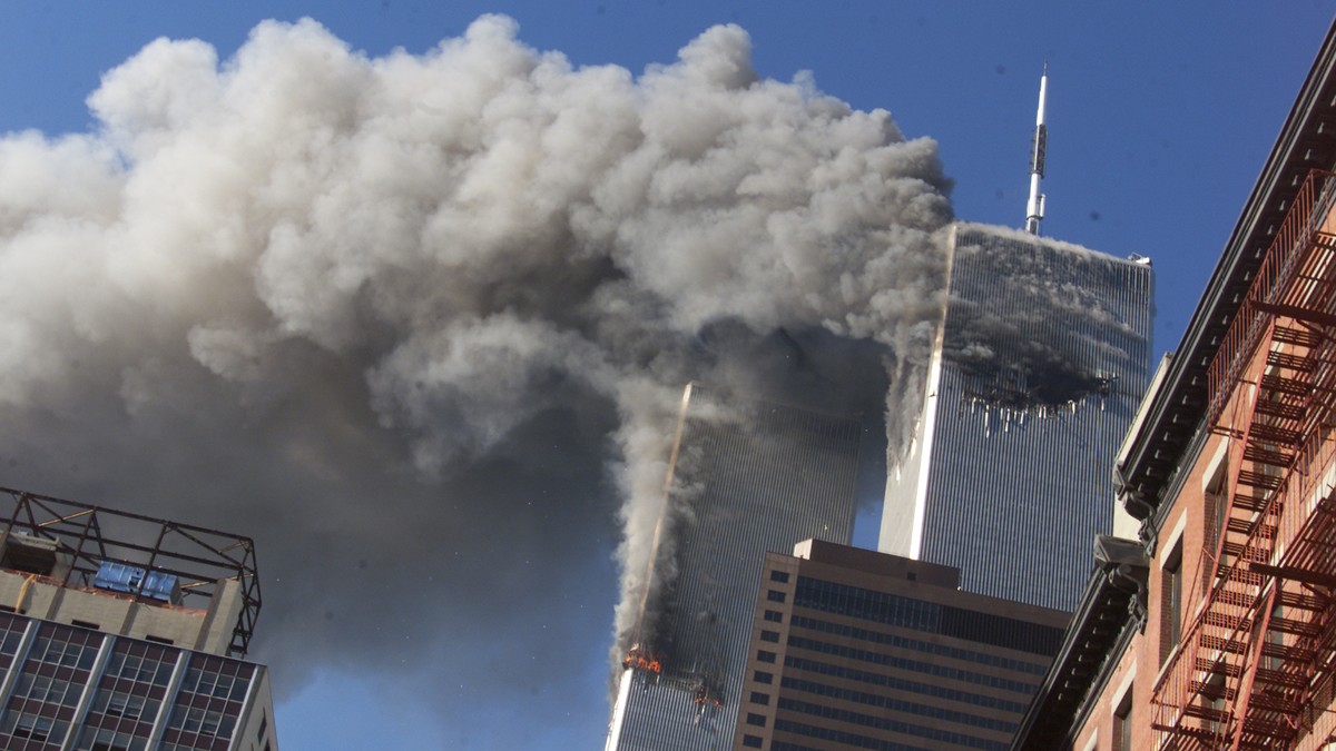 FILE - Smoke rises from the burning twin towers of the World Trade Center after hijacked planes crashed into the towers on September 11, 2001 in New York City. Associated Press photographer Richard Dr ...