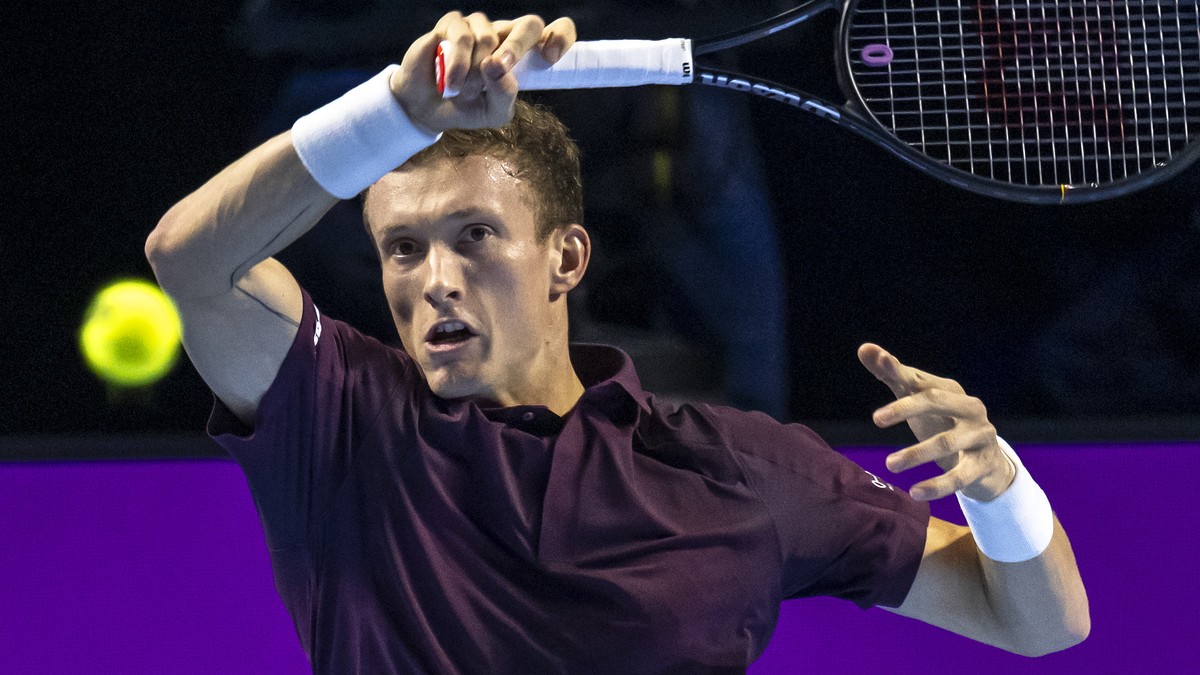 Czech Republic's Jiri Lehecka returns a ball to Switzerland's Stan Wawrinka during their first round match at the Swiss Indoors tennis tournament at the St. Jakobshalle in Basel, Switzerland ...