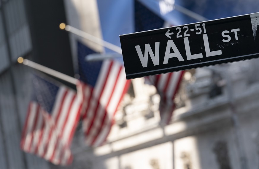 FILE - A sign for Wall Street hangs in front of the New York Stock Exchange, July 8, 2021. Wall Street delivered another strong year for investors in 2021, as a resurgence in consumer demand fueled by ...