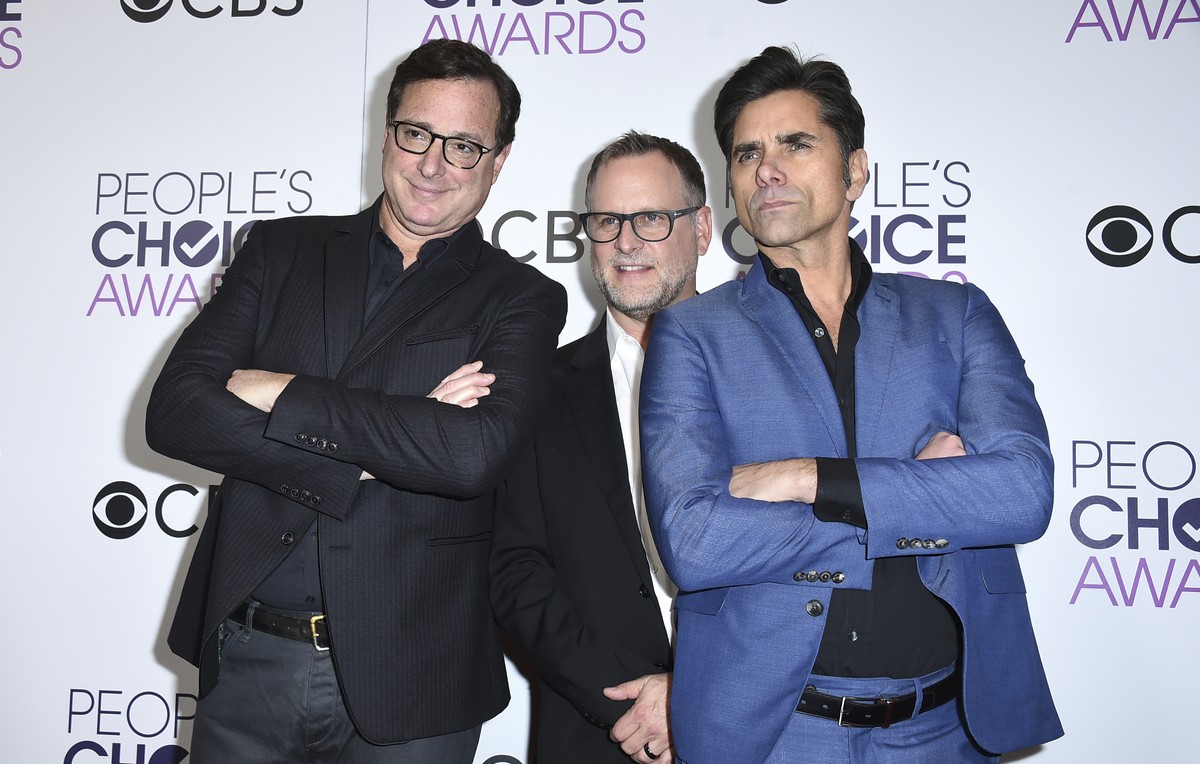 FILE - Bob Saget, from left, Dave Coulier and John Stamos, winners of the award for favorite premium comedy series for "Fuller House," pose in the press room at the People's Choice Awar ...