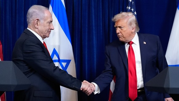 President Donald Trump shakes hands with Israel's Prime Minister Benjamin Netanyahu at the end of a news conference at Mar-a-Lago, Dec. 29, 2025, in Palm Beach, Fla. (AP Photo/Alex Brandon, File) ...