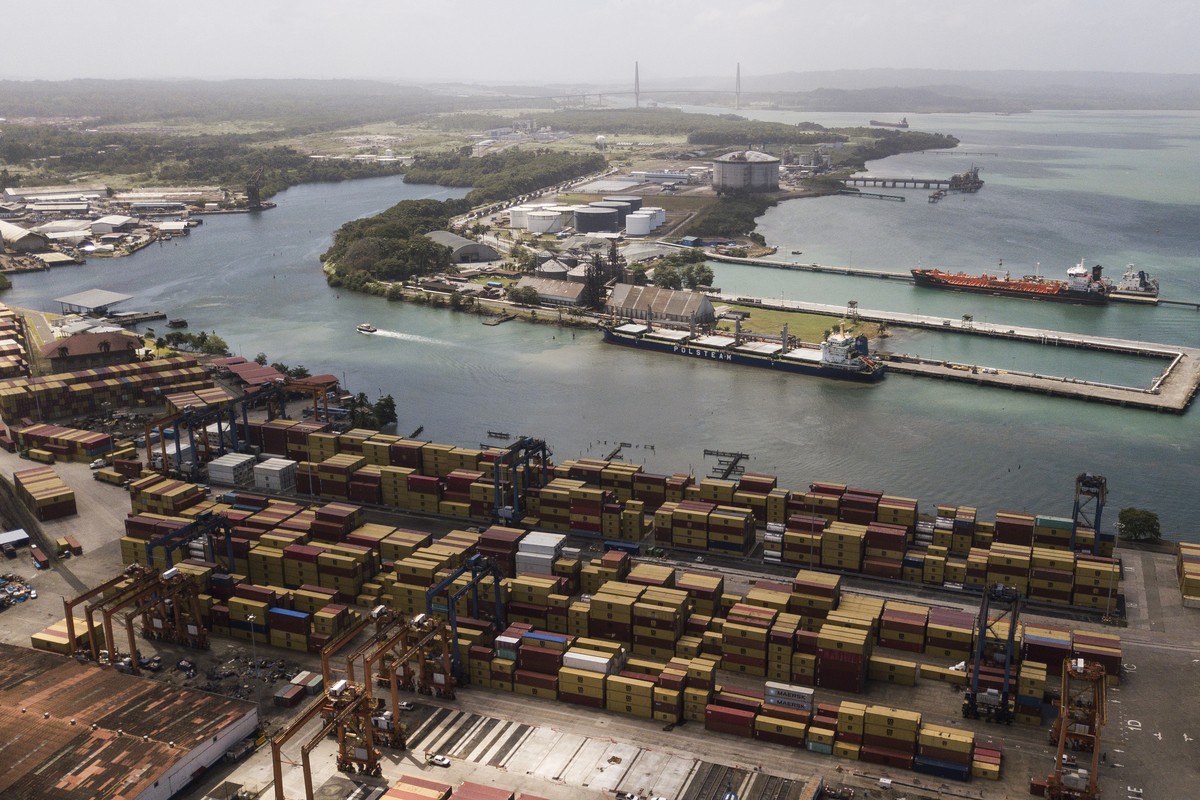 Cargo containers sit stacked as cranes load and unload containers from cargo ships at the Cristobal port, operated by the Panama Ports Company, in Colon, Tuesday, Panama, Feb. 4, 2025. (AP Photo/Matia ...