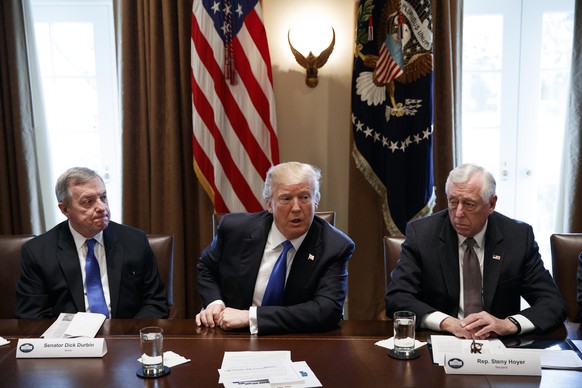 In this Jan. 9, 2017, photo, Sen. Dick Durbin, D-Ill., left, and Rep. Steny Hoyer, D-Md. listen as President Donald Trump speaks during a meeting with lawmakers on immigration policy in the Cabinet Ro ...