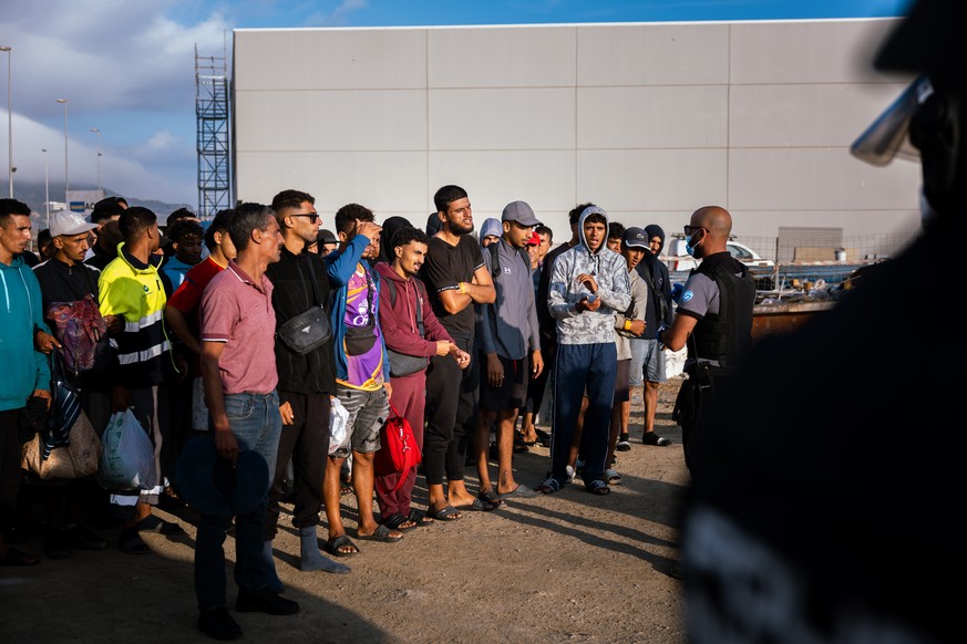 epa13248029 A handout picture provided by Spain's Ministry of Inclusion, Social Security and Migration shows migrants who had been living at Benitez Beach arriving at a new temporary reception ce ...