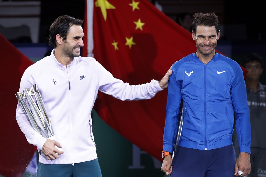 Roger Federer of Switzerland, left, gestures with Spain&#039;s Rafael Nadal after winning their men&#039;s singles final match in the Shanghai Masters tennis tournament at Qizhong Forest Sports City T ...