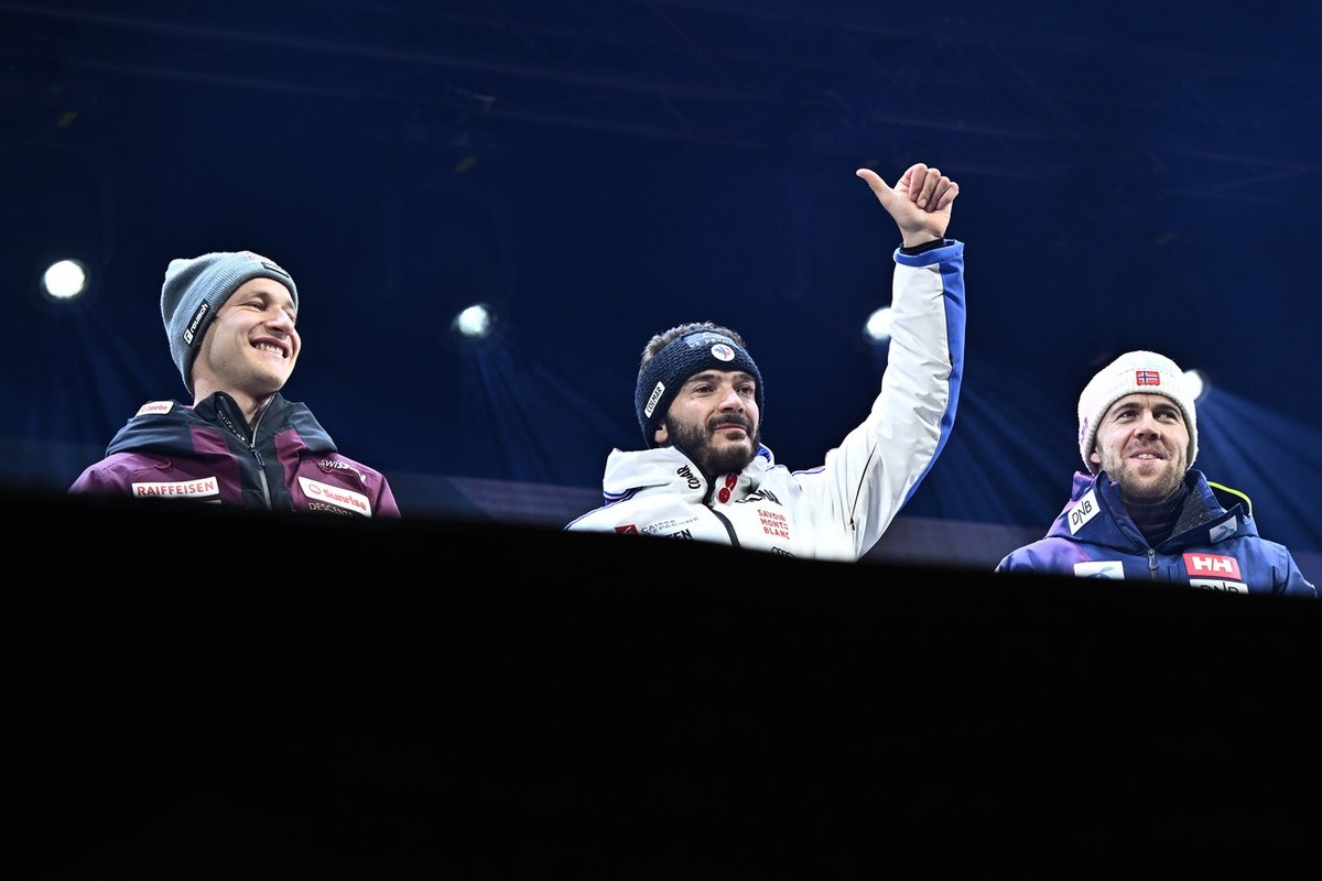Cyprien Sarrazin of France, winner, center, Marco Odermatt of Switzerland, 2nd place, left, and Aleksander Aamodt Kilde, of Norway, 3rd place, celebrate during the award ceremony after the men's ...