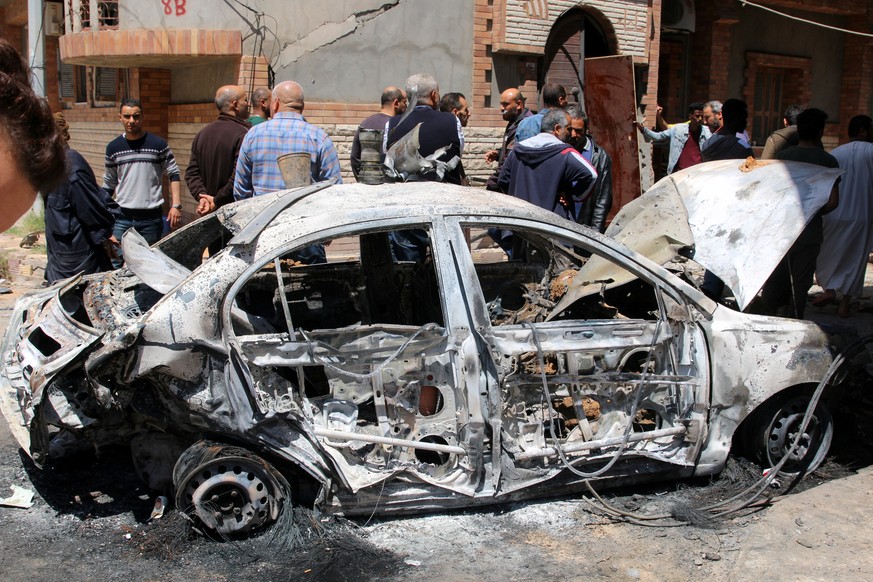 epa07512400 People inspect the damage after overnight shelling on the southern district of Abu Salim, Tripoli, Libya, 17 April 2019. According to media reports, four people were killed and dozens inju ...