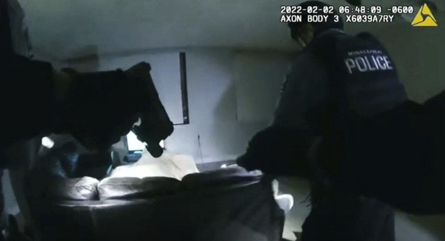 In this image taken from Minneapolis Police Department body camera video and released by the city of Minneapolis, Minneapolis police enter an apartment on Wednesday, Feb. 2, 2022, moments before shoot ...