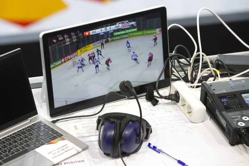 A screen shows the game for reporters, during the IIHF 2021 World Championship preliminary round game between Switzerland and Great Britain, at the Olympic Sports Center, in Riga, Latvia, Tuesday, Jun ...