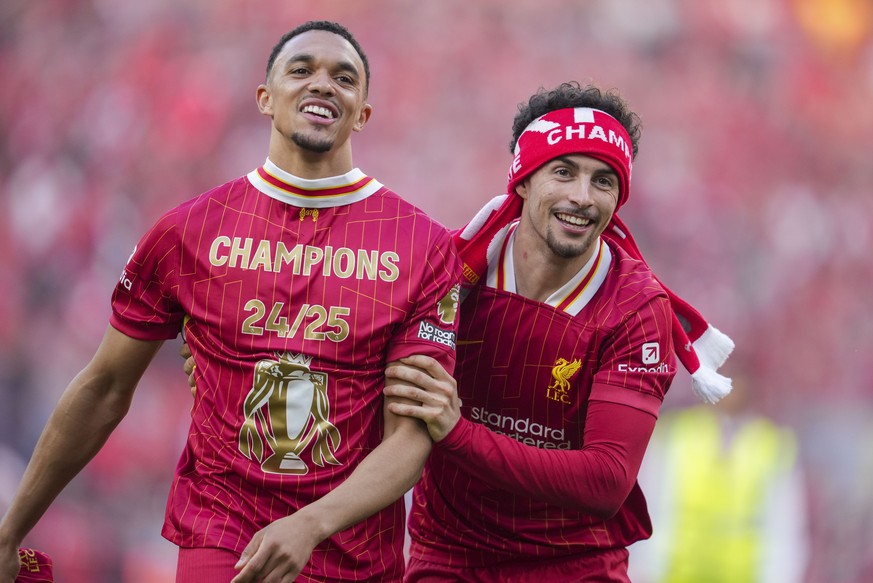 Liverpool's Trent Alexander-Arnold, left, and Curtis Jones celebrate after winning the English Premier League soccer match between Liverpool and Tottenham Hotspur and clinching the Premier League ...