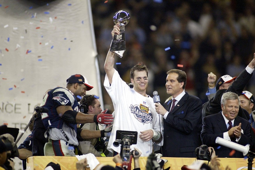 SUPER BOWL XXXVIII Feb 1, 2004 Houston, TX, USA FILE PHOTO New England Patriots quarterback Tom Brady 12 celebrates with the Vince Lombardi Trophy after defeating the Carolina Panthers during Super Bo ...