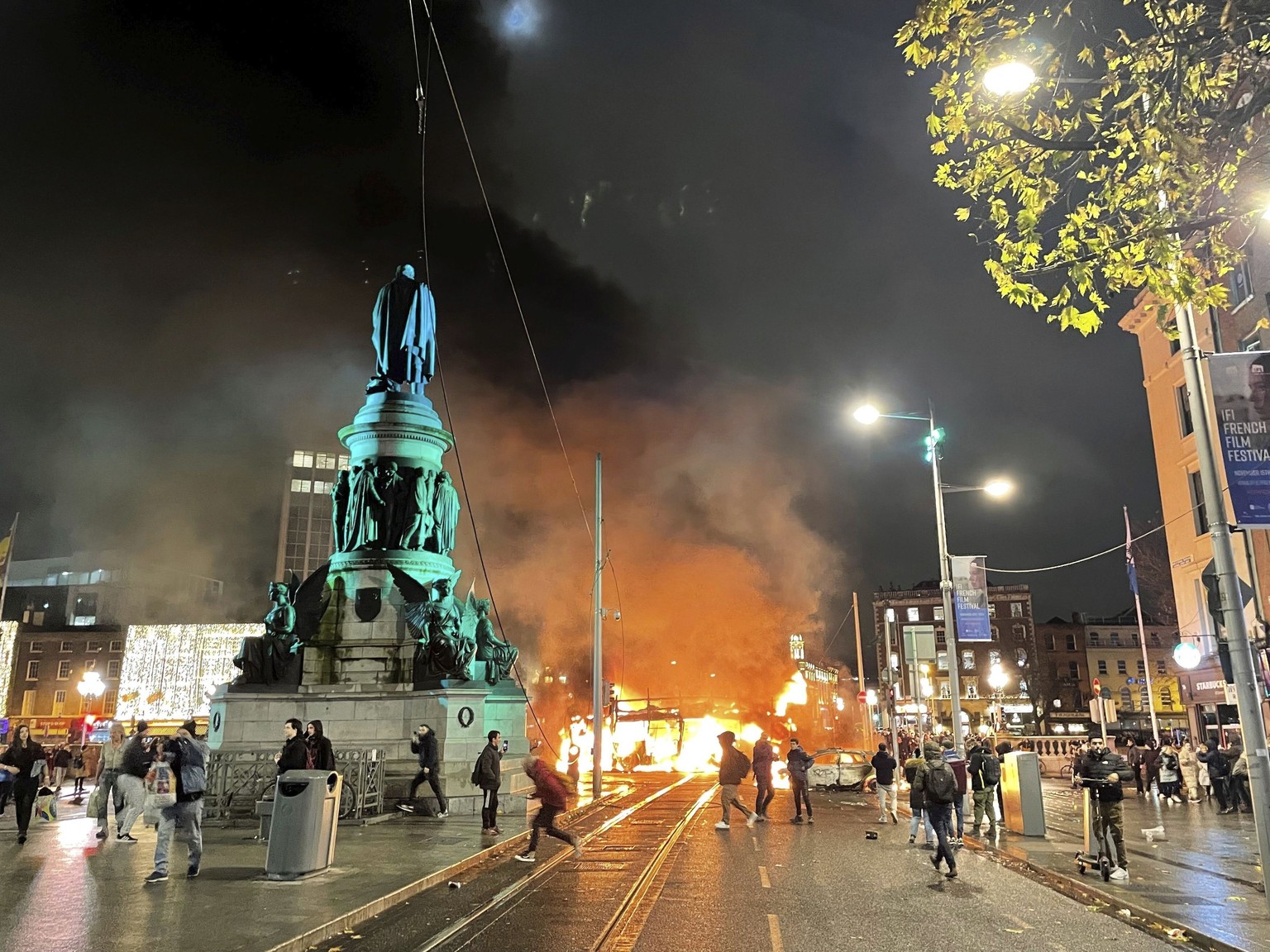 A bus and car on fire after violent scenes unfolded in Dublin city center, Thursday Nov. 23, 2023 following a knife attack. A 5-year-old girl is receiving emergency medical treatment in a Dublin hospi ...