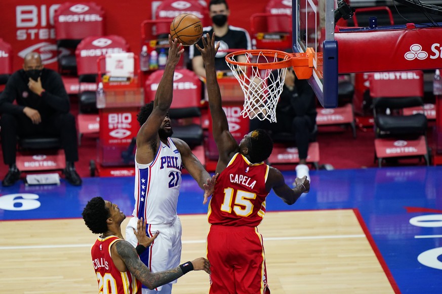 Philadelphia 76ers&#039; Joel Embiid (21) goes up for a shot between Atlanta Hawks&#039; Clint Capela (15) and John Collins (20) during the second half of an NBA basketball game, Wednesday, April 28,  ...