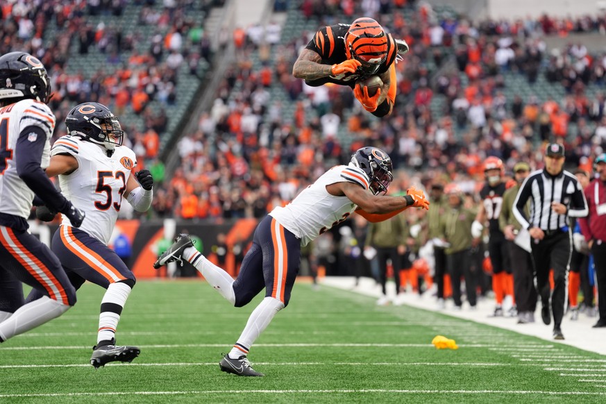 Cincinnati Bengals running back Chase Brown (30) hurdles Chicago Bears defensive back Kevin Byard III (31) on a run during an NFL football game, Sunday, Nov. 2, 2025, in Cincinnati. (AP Photo/Kareem E ...
