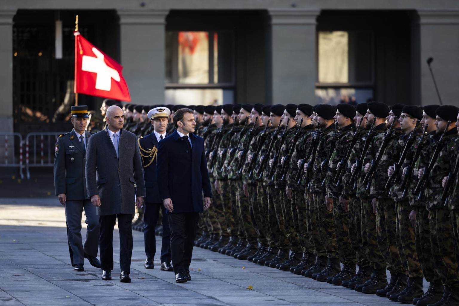 French President Emanuel Macron, right, and Swiss Federal President Alain Berset, left, inspect the guard of honour of the Swiss army in front of the Federal Palace, the Swiss Parliament building, in  ...