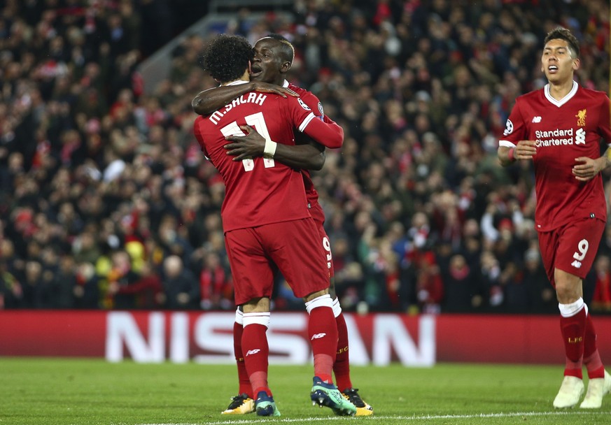 Liverpool&#039;s Sadio Mane celebrates with Mohamed Salah, left, and Roberto Firmino, right, after scoring his side&#039;s third goal during the Champions League semifinal, first leg, soccer match bet ...