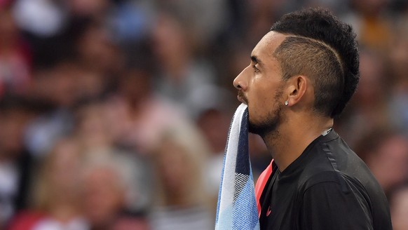 Australia&#039;s Nick Kyrgios bites towel while playing Brazil&#039;s Rogerio Dutra Silva during their first round match at the Australian Open tennis championships in Melbourne, Australia, Monday, Ja ...