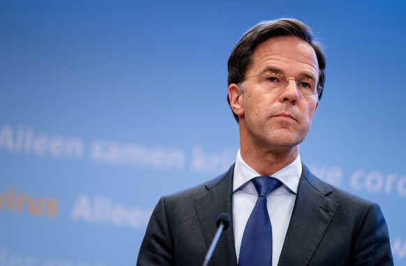 epa08506676 Dutch Prime Minister Mark Rutte and Minister Hugo de Jonge of Health, Welfare and Sport (CDA) and sign interpreter Irma Sluis during the press conference after a consultation of the Minist ...