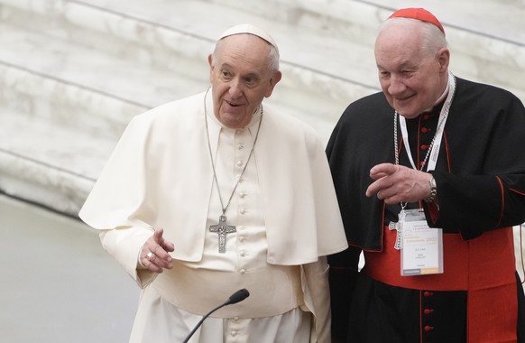 Pope Francis, left, and Cardinal Marc Ouellet arrive at the opening of a 3-day Symposium on Vocations in the Paul VI hall at the Vatican, Thursday, Feb. 17, 2022. (AP Photo/Gregorio Borgia)