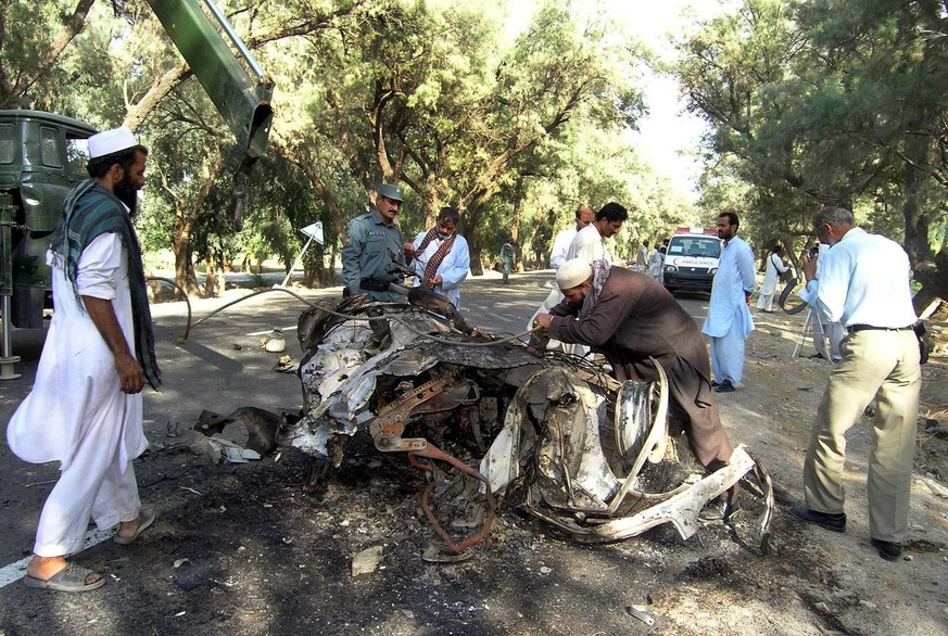An Afghan man tries to tie the wreckage of the suicide attacker&#039;s vehicle for loading after a suicide attack in Bati Kot district of eastern Nangarhar province of Afghanistan on Saturday, Sept. 2 ...