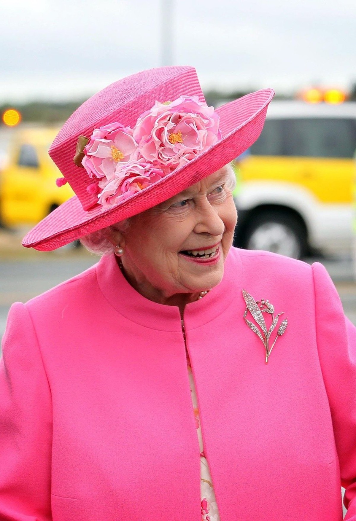 In matching pink hat and topcoat Britain's Queen Elizabeth II arrives with a smile at Perth International airport 26 October 2011 to attend the Commonwealth Heads of Government Summit as part of  ...